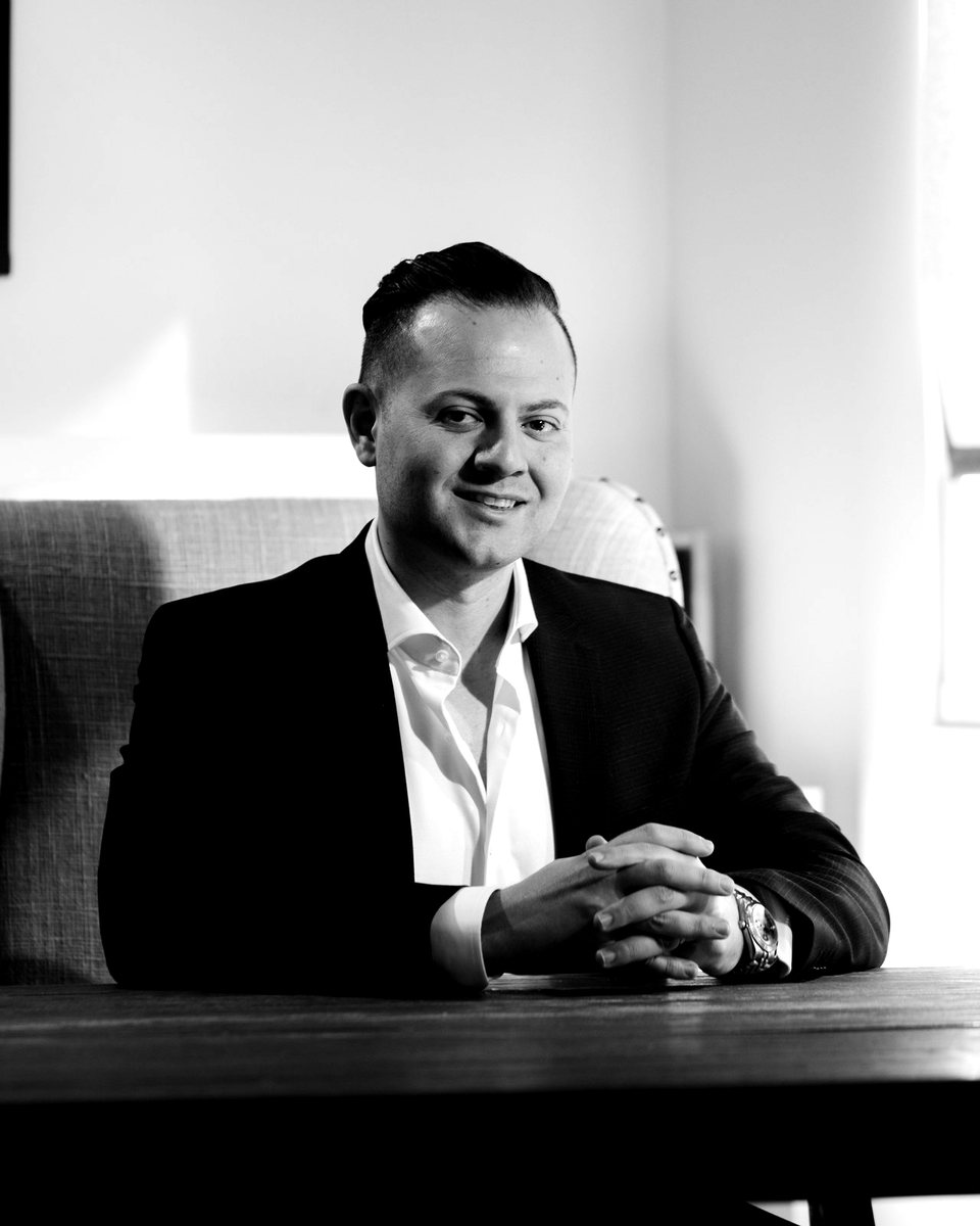 Amir Rad, M.D., seated at a consultation table.